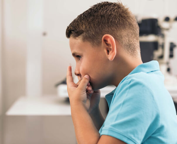 Boy putting on contact lens