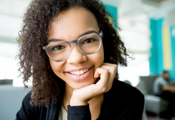 Girl smiling wearing glasses for Myopia