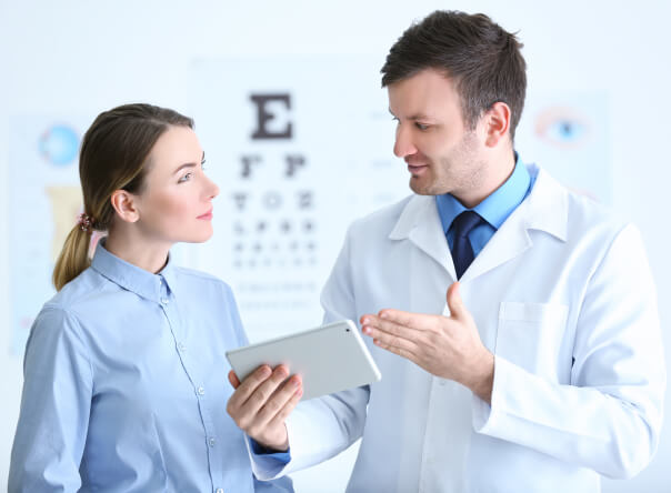 Male doctor talking to female patient