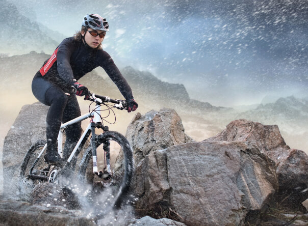 Man biking on snowing mountain