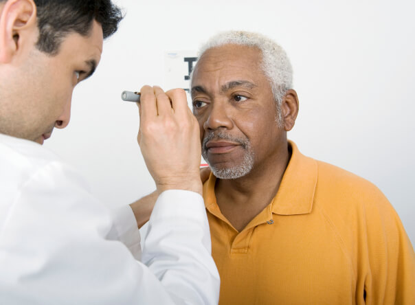 Doctor performing eye exam to patient