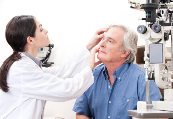 Female doctor performing diabetic eye exam to patient