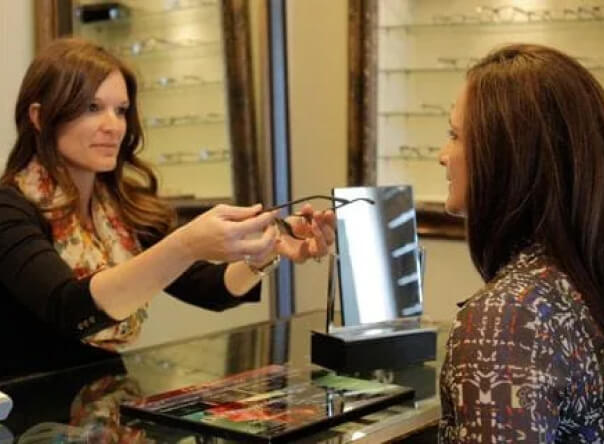 Woman giving patient her glasses