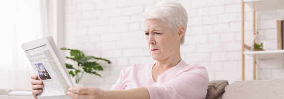 Woman reading a paper at a distance