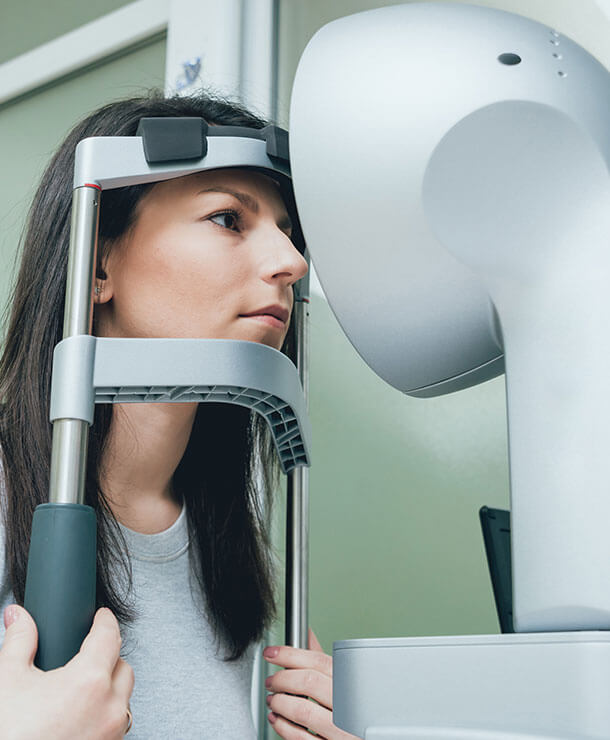 Woman undergoing corneal disease eye exam