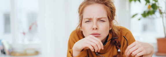 Woman with refractive disorder squinting