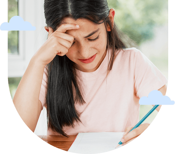 a girl in a pink shirt concentrates on writing and thinking